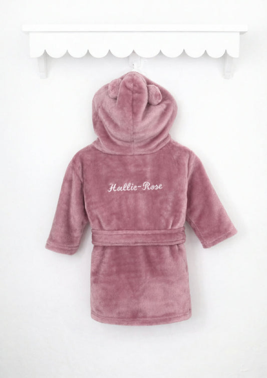 Pink plush robe with hood on a white background