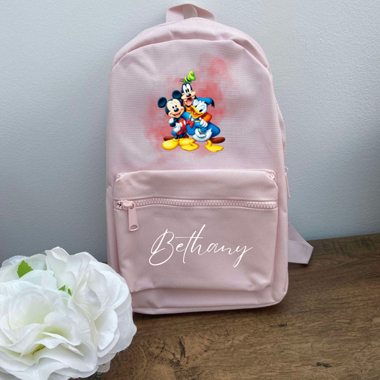 A pink personalised backpack featuring a graphic of Mickey Mouse and two other cartoon characters on the front, with the name 'Bethany' printed on the bottom.