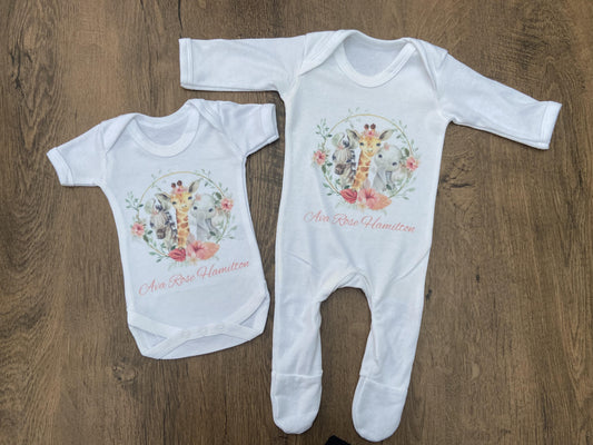 White baby vest and sleepsuit with safari design