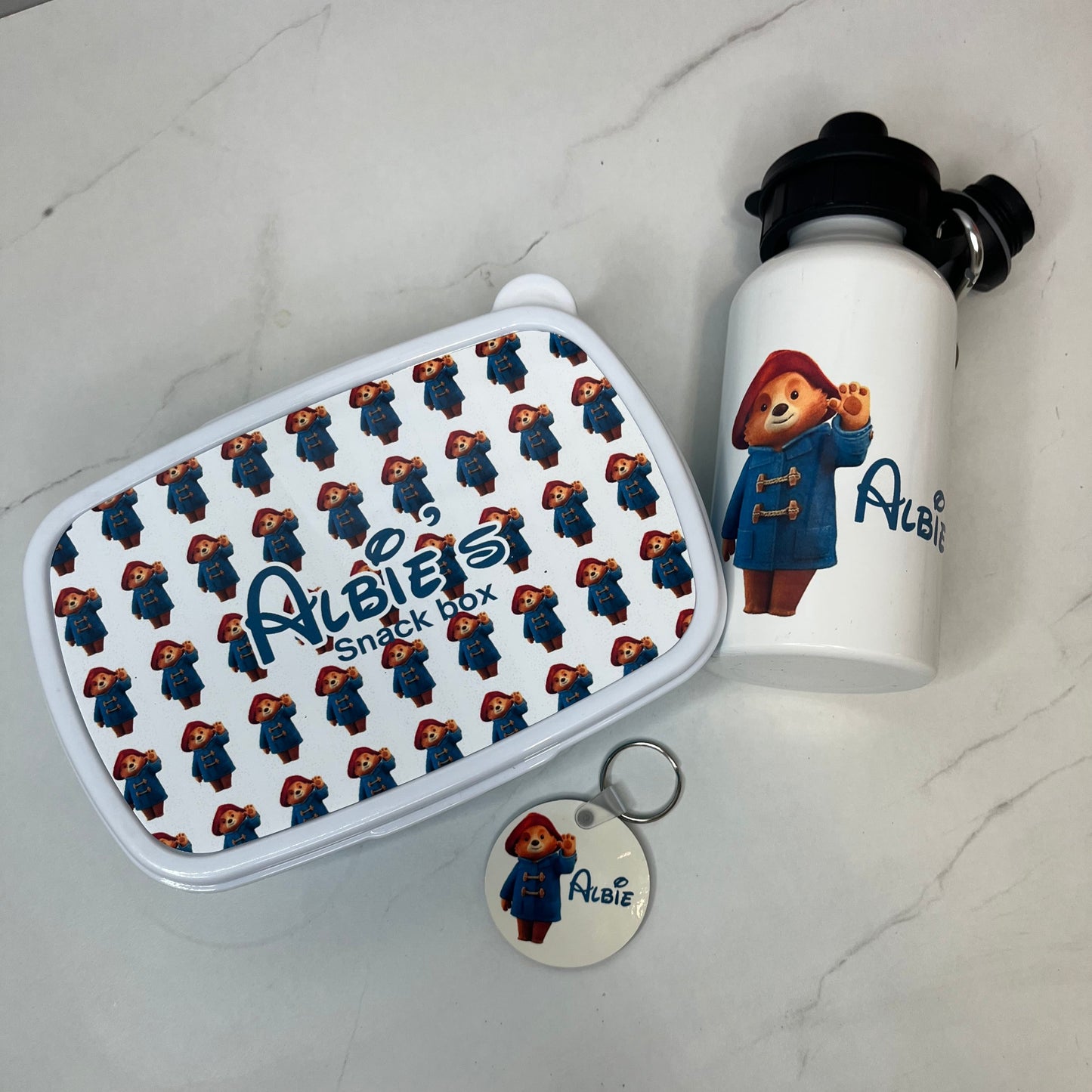 A image of a personalised snack box, water bottle and keyring