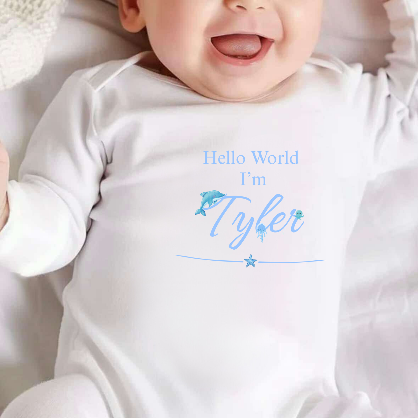 Baby wearing a white onesie with 'Hello World I'm Tyler' text and graphics.