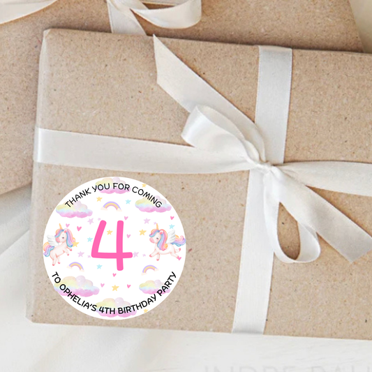 Gift box wrapped in brown paper with a white ribbon and a personalized birthday sticker.