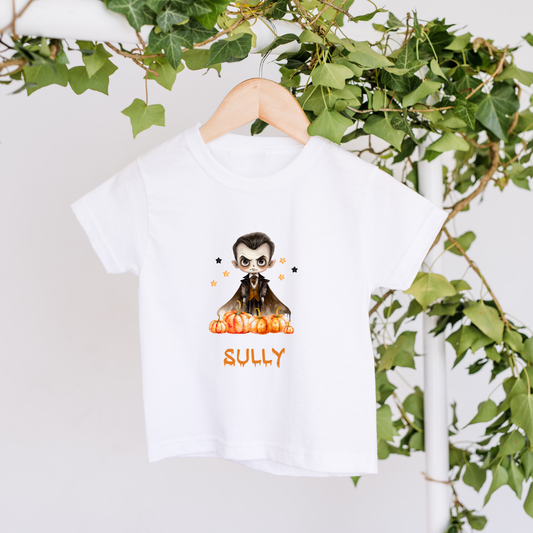 White t-shirt with a character design and 'Sully' text on a hanger with green leaves in the background