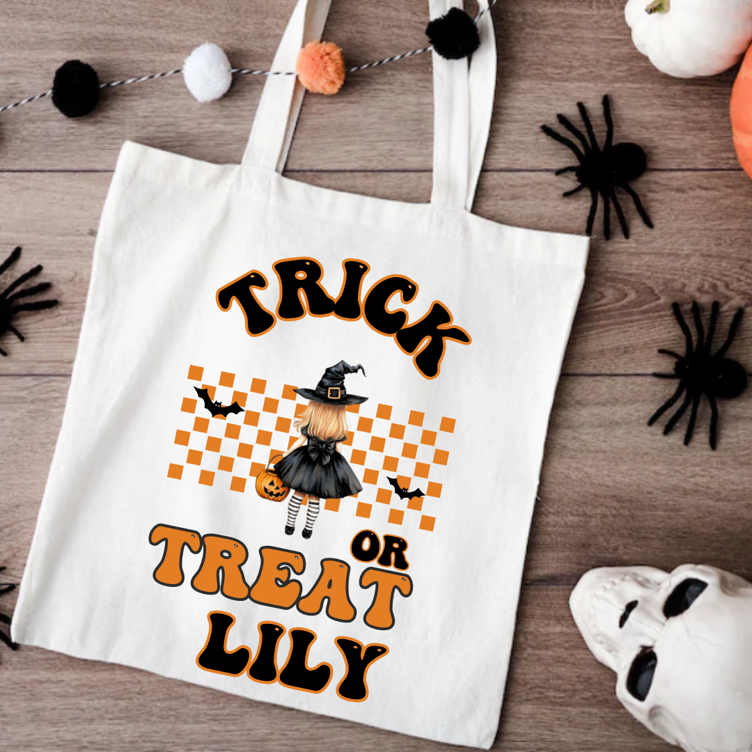 Halloween-themed tote bag with text and graphics on a wooden surface.