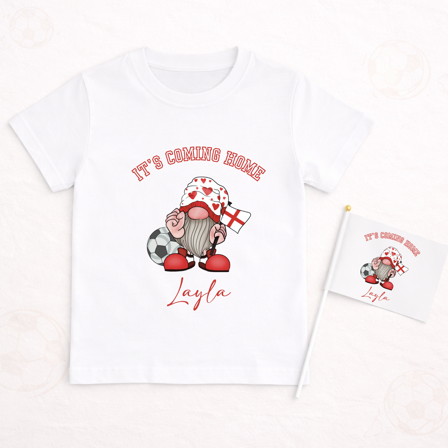 White t-shirt with a gnome graphic and text 'It's Coming Home Layla' on a white background