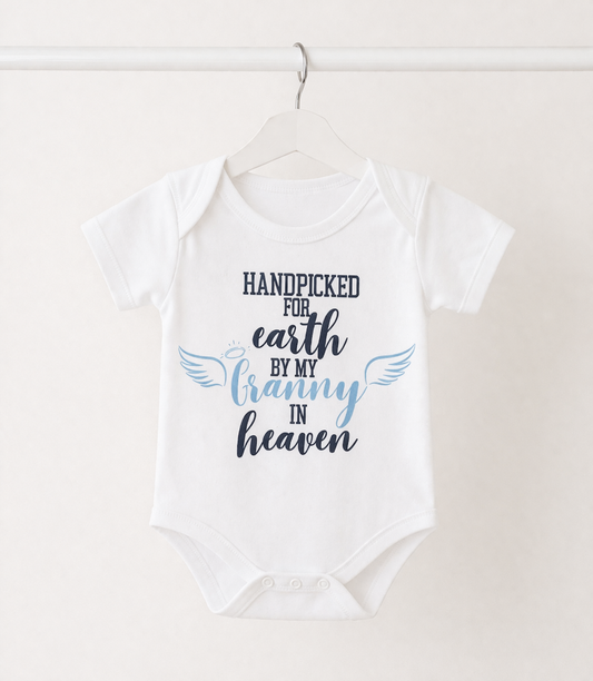 Personalised baby onesie with “Handpicked for Earth by my Granny in Heaven” design hanging on white rail, memorial baby vest gift