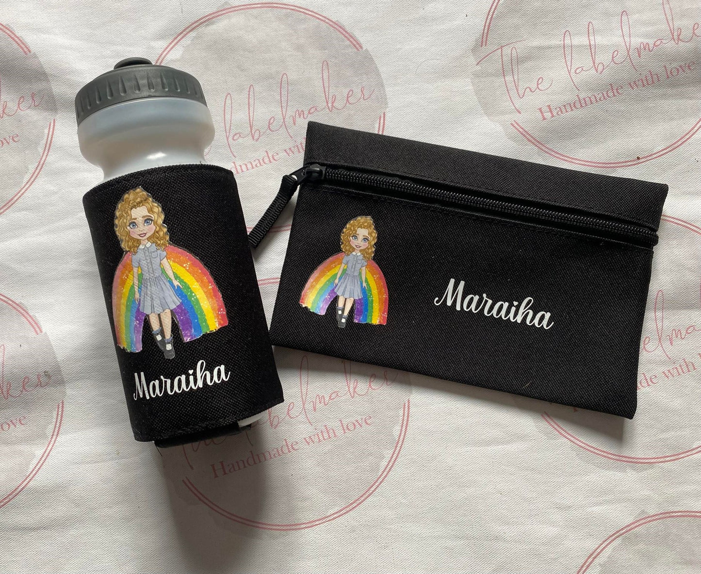 Black personalised pencil case with image of a person with a rainbow and  a name