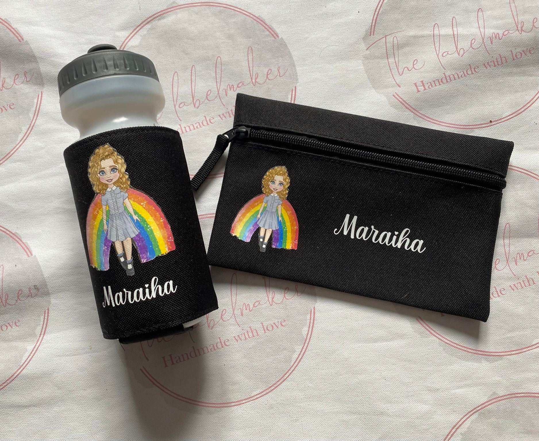 Black personalised pencil case with image of a person with a rainbow and  a name