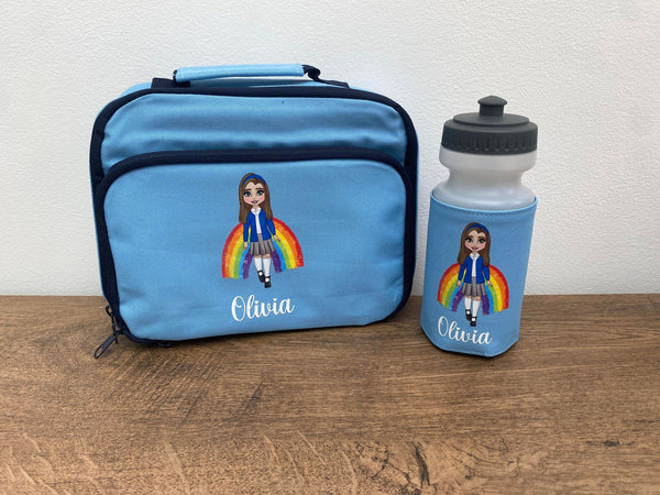 A personalized lunch bag and bottle set for kids, with the name 'Olivia' on them. The bag is blue with a picture of a girl wearing a rainbow-themed outfit, and there's a white bottle with a blue cap, also featuring the name 'Olivia'.