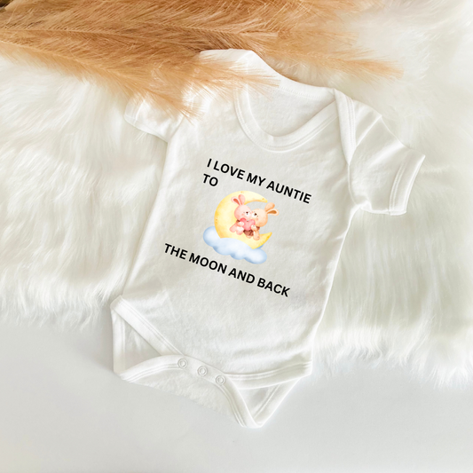 A white baby vest with the text 'I LOVE MY AUNTIE TO THE MOON AND BACK' printed on the front, featuring an illustration of a bear.
