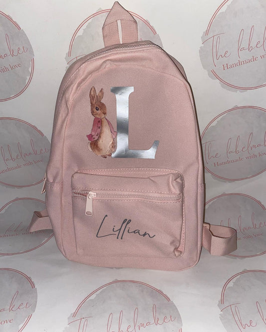 A pink personalised backpack for children with a floppy rabbit design, featuring a name 'Lifian' on the front pocket.