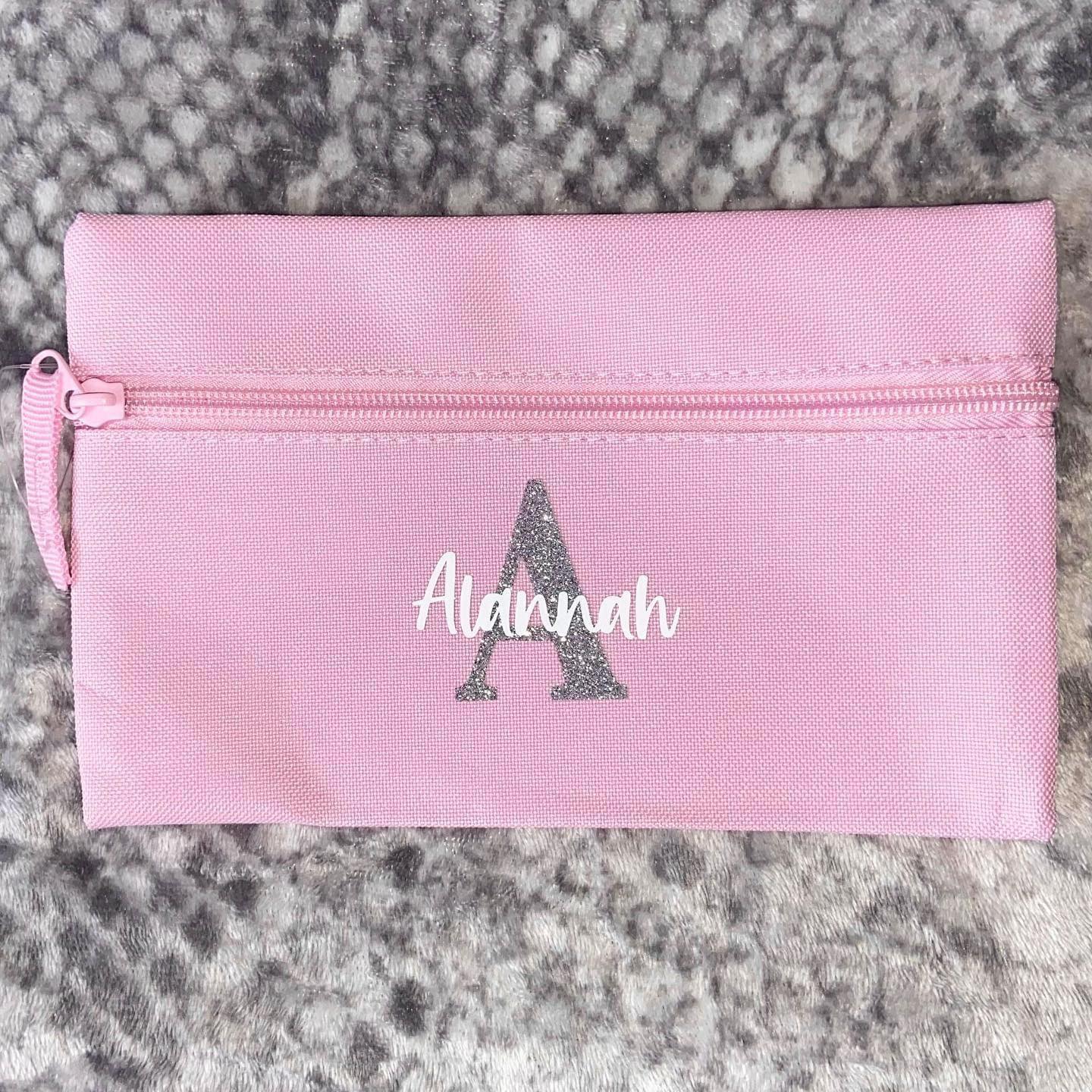 Pink pencil case with a name and initals in silver and white
