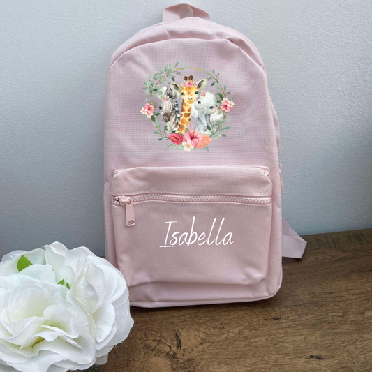 A pink personalised safari backpack with a floral and animal pattern, featuring a name 'Isabella' on the front.