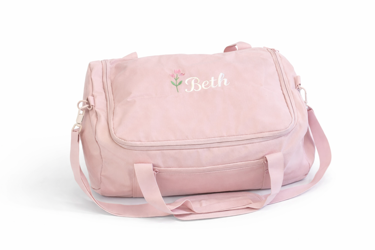 Pink duffel bag with 'Beth' embroidered on a white background