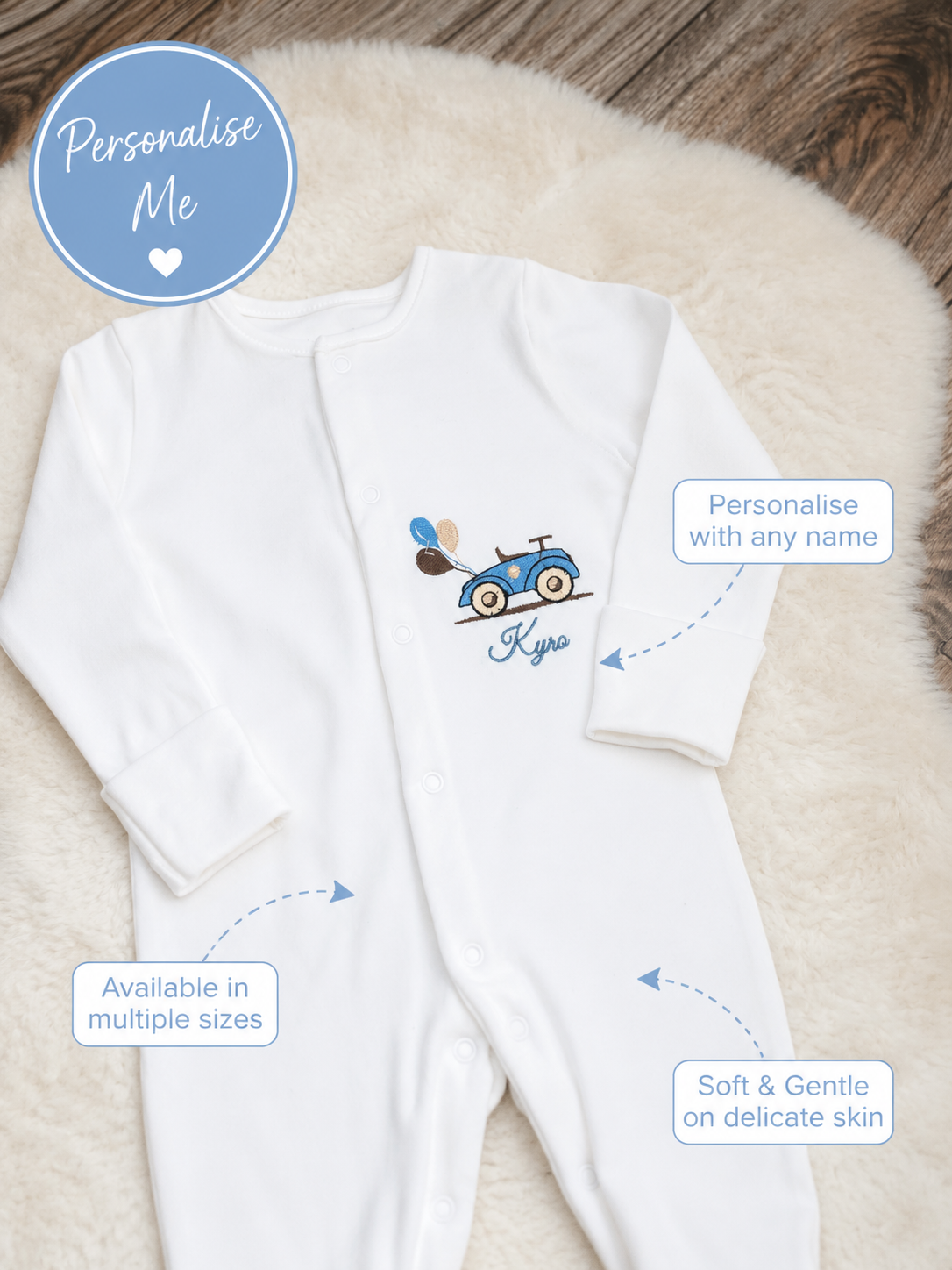 Personalised white baby sleepsuit embroidered with blue car design and custom baby name