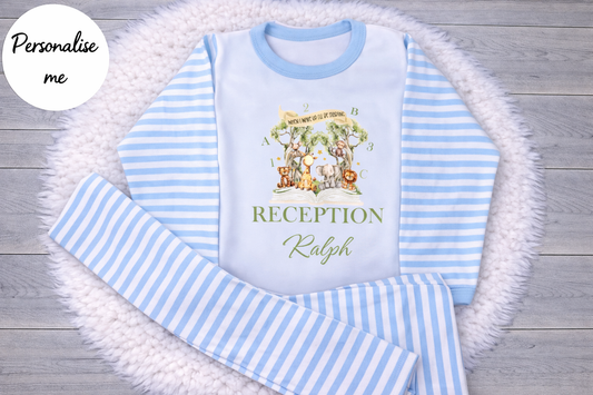 Children's blue and white striped pajama set with a printed design on a wooden surface.