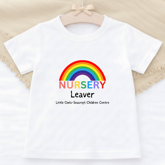 White t-shirt with rainbow and text on a beige background