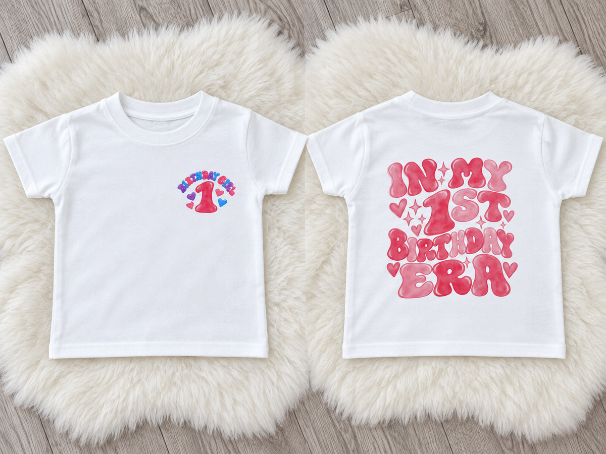 White first birthday T-shirt with small Birthday Girl chest design and large pink In My 1st Birthday Era print on the back