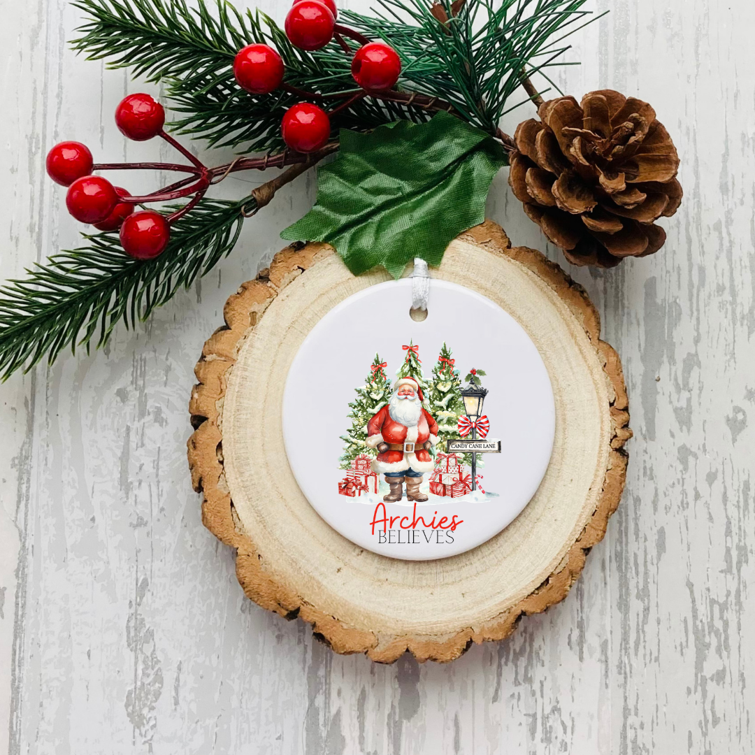 Personalised ceramic Christmas bauble with Santa, festive trees and family Christmas wording