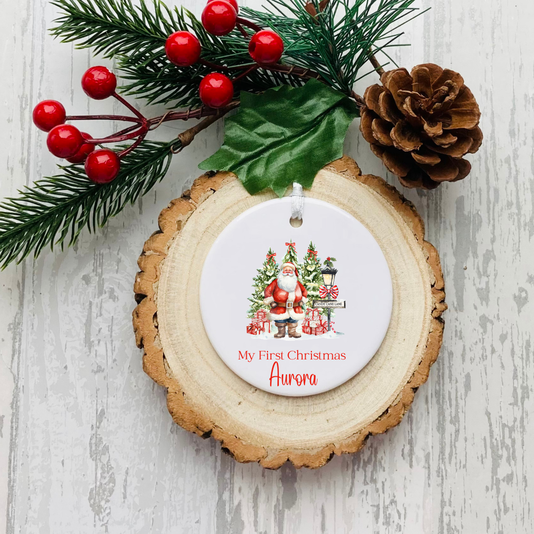 Personalised ceramic Christmas bauble with red Santa and festive trees My First Christmas design