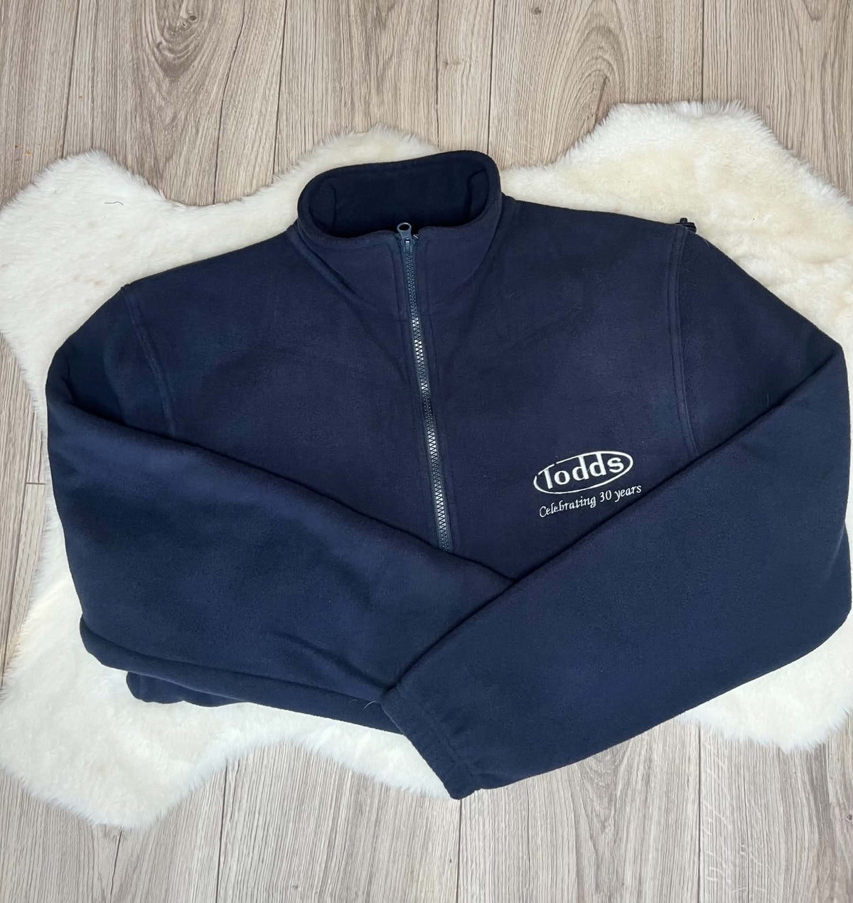 Navy full zip fleece embroidered with white Todds business logo and Celebrating 30 years wording