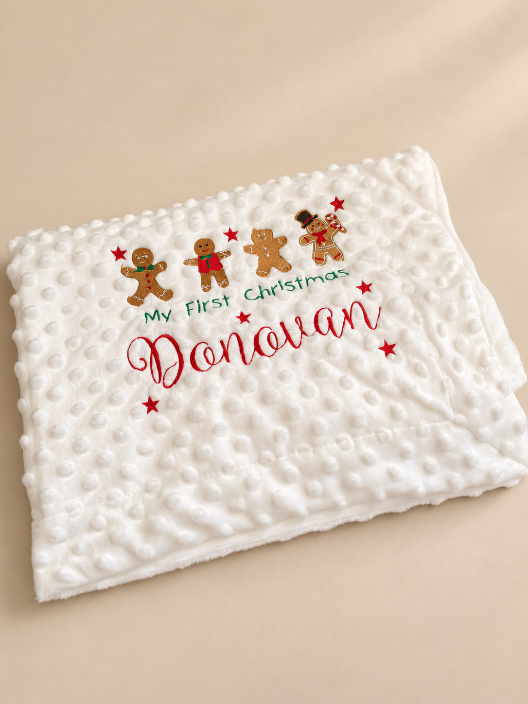 White textured baby blanket with gingerbread embroidery and personalised Christmas wording