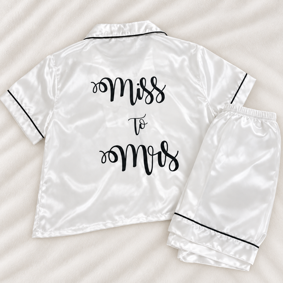 Back of white personalised bridal satin pyjamas printed with Miss To Mrs in black script