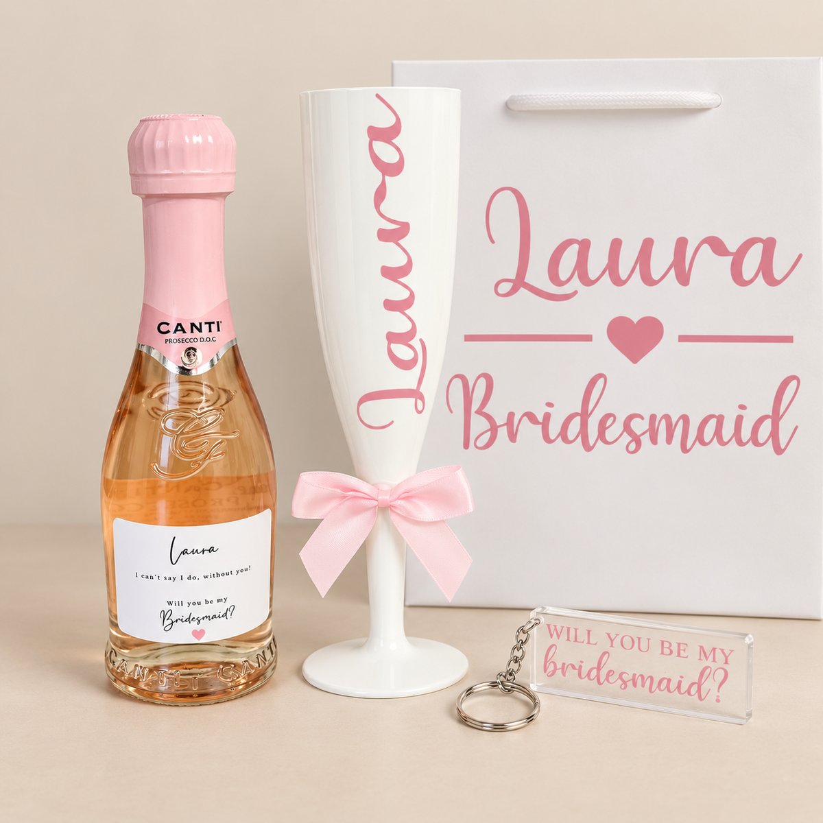 Personalised Laura bridesmaid proposal gift set with mini prosecco, champagne flute, gift bag and acrylic keyring