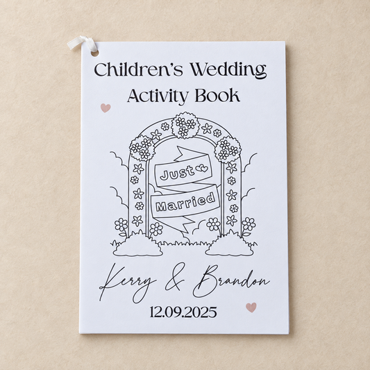 Personalised children’s wedding activity book with Just Married cover on a warm beige background