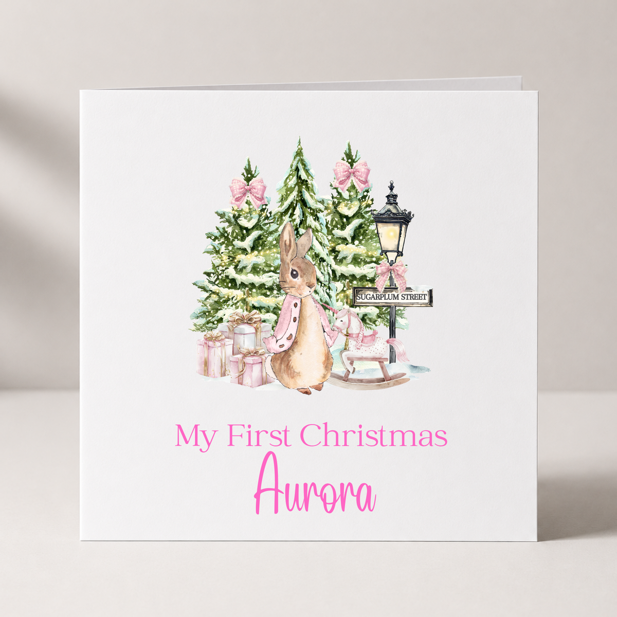 Pink Peter Rabbit Baby's First Christmas Card with custom names and wording