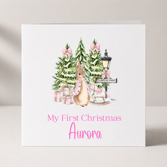 Pink Peter Rabbit Baby's First Christmas Card with custom names and wording