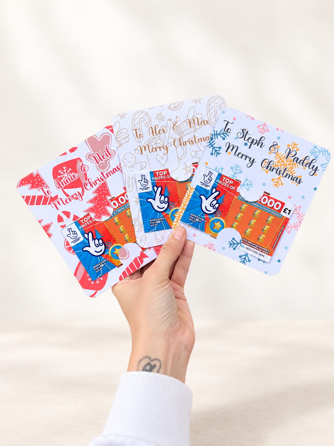 Personalised Christmas scratch card holders showing red, gingerbread and snowflake designs