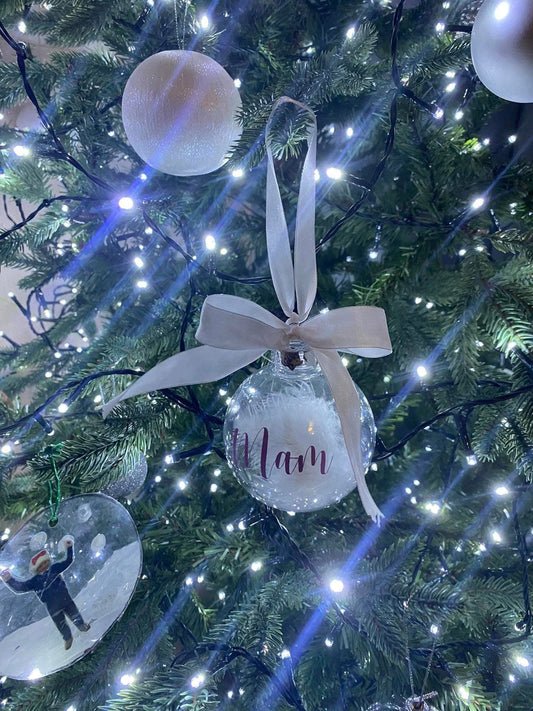 Clear feather filled Christmas bauble with personalised text and white ribbon