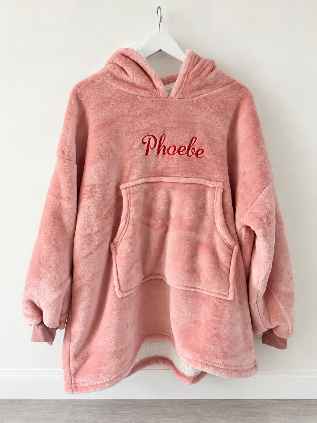 Personalised blush pink children's hooded blanket with Phoebe embroidered on front