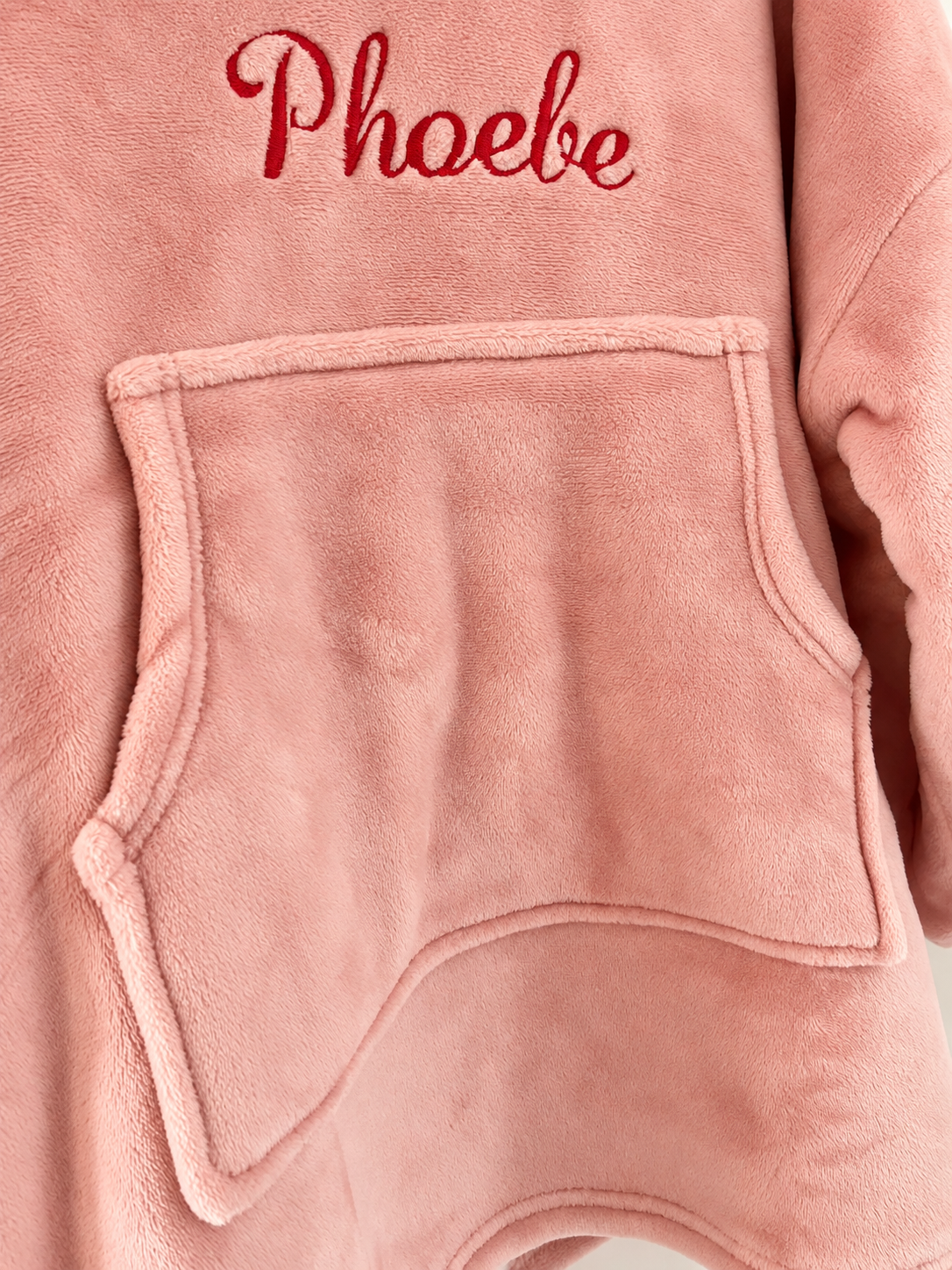 Front pouch pocket detail of blush pink hooded blanket