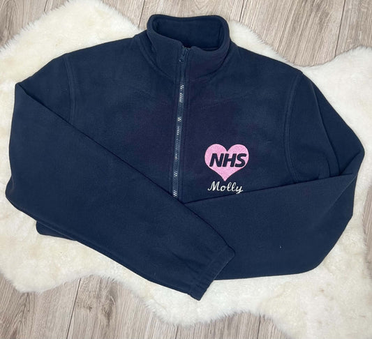 Navy fleece embroidered with a pink NHS heart and Molly in white script