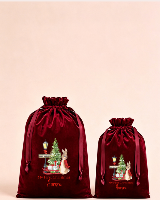 Personalised red velvet Christmas sack in medium and large with woodland animals around a Christmas tree